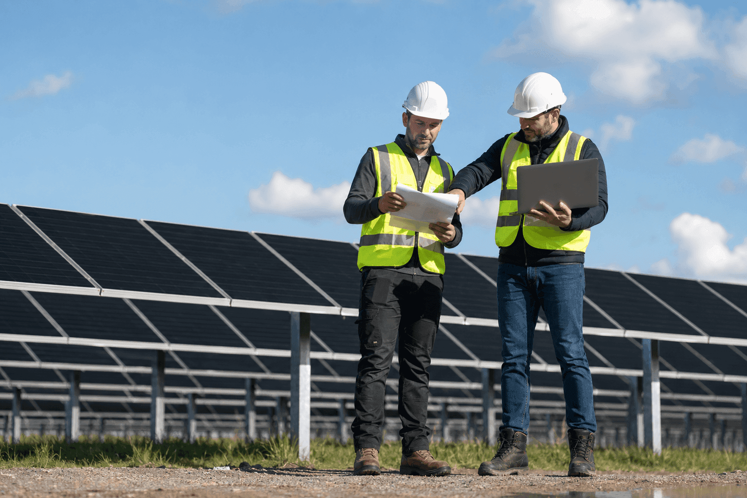 Engineers with solar panels and a laptop